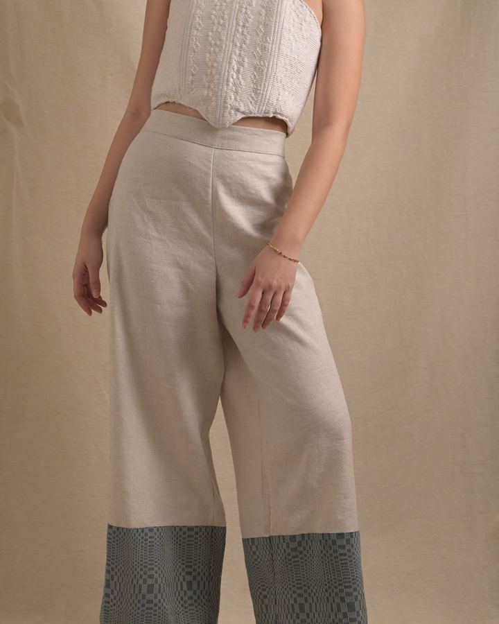 Cream wide-leg trousers with a deep Binakol hem